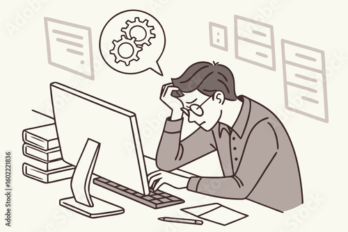 Frustrated professional working on a computer while troubleshooting a problem in an office environment