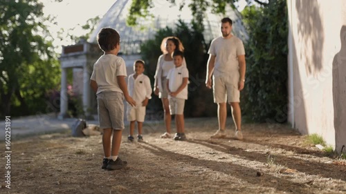 Happy family playing leapfrog in a park