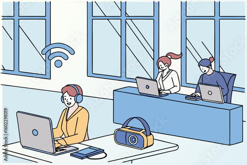 Three people working in a modern office setting with laptops and headphones during a bright day