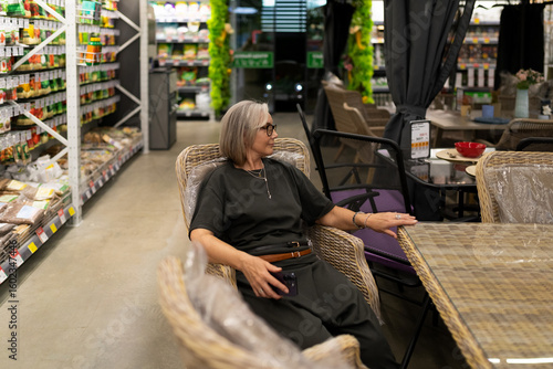 Woman shop at a large home improvement store exploring various departments for household and gardening needs