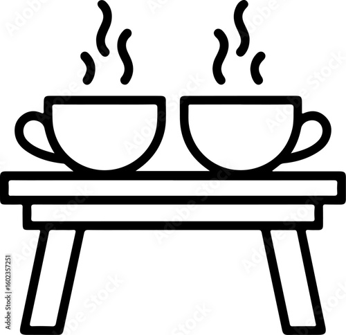 Two steaming cups of hot beverage on a simple wooden table with legs