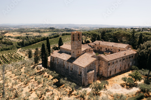 Fotografie Sant'antimo abbey in tuscany, italy, surrounded by vineyards and olive groves, d