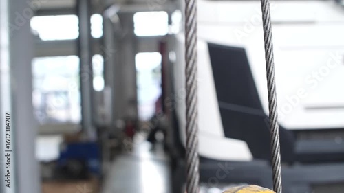 Wallpaper Mural Yellow crane hook rotating unfolding, revealing strong metal structure. Torontodigital.ca