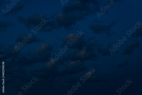 Wallpaper Mural A large, dark cloud floats in a deep twilight sky, tinted with faint pink light, creating a minimalist, moody scene with ample space for text. Torontodigital.ca