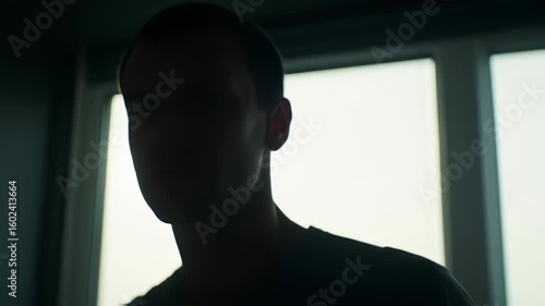 Silhouette of a person by window