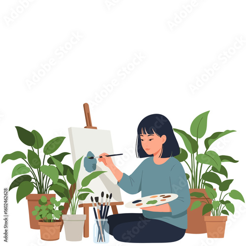 Young woman engrossed in her painting hobby, finding creative solace while sitting on the floor surrounded by lush green houseplants.