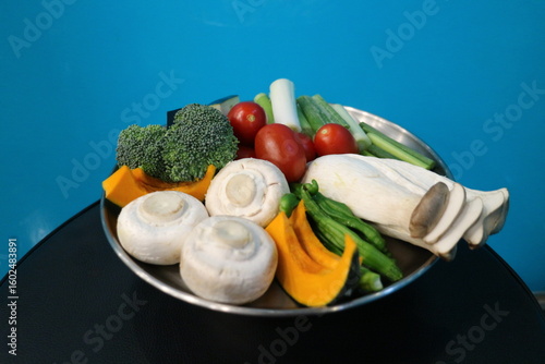 Korean Barbecue Grill Setup with Fresh Beef, Side Dishes, and Vegetables at Traditional Restaurant Table