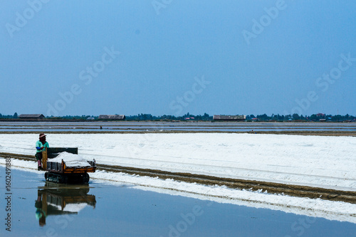 Pyramids of sea salt ready to be harvested in a salt farm at sunrise. Used as a seasoning in food, cosmetics and for food preservation.