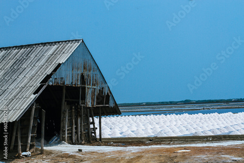 Pyramids of sea salt ready to be harvested in a salt farm at sunrise. Used as a seasoning in food, cosmetics and for food preservation.
