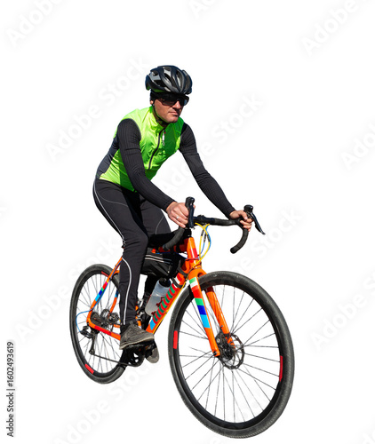 Cyclist riding bicycle on road against clear sky