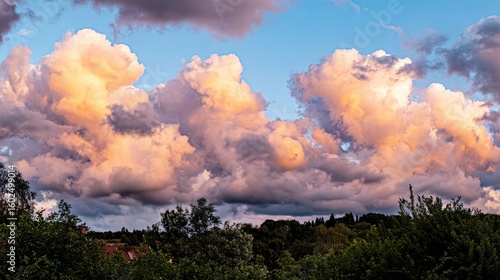 Dramatic golden hour sky with vibrant sunset hues blending into dynamic cloud formations, capturing nature's grandeur.
