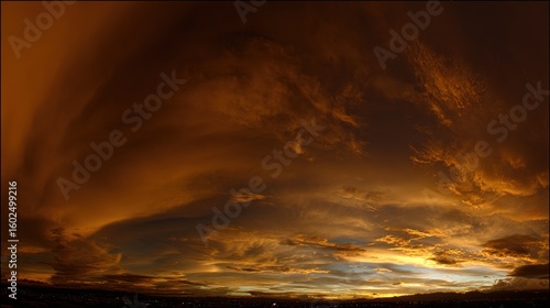 Dramatic golden hour sky with vibrant sunset hues blending into dynamic cloud formations, capturing nature's grandeur.