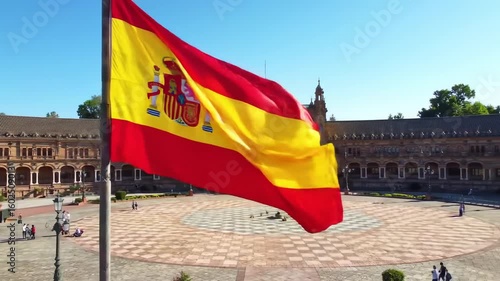 Spanish flag waving over a plaza
