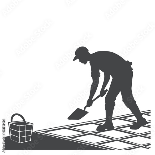 Silhouette of Construction Worker Laying Tiles with Trowel on Floor
