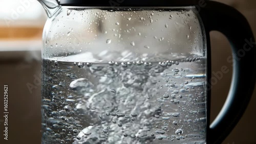 Water boiling in transparent glass kettle