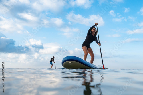 Focused woman enjoying a paddleboard challenge