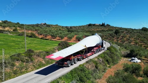 Large wind turbine blade being transported on a specialized truck
