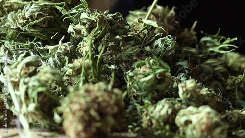 Cannabis flowers falling and accumulating on a pile