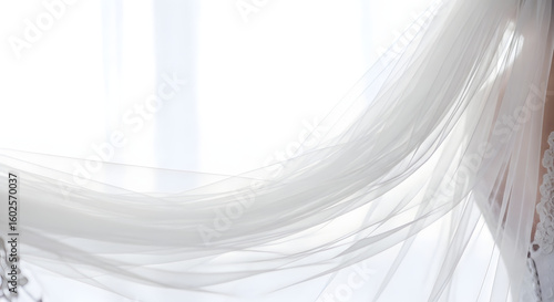 Close-up of a flowing white wedding veil, partially obscuring a window, suggesting elegance and anticipation.