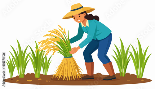 Smiling female farmer in a straw hat and boots harvesting a golden sheaf of rice in a field.