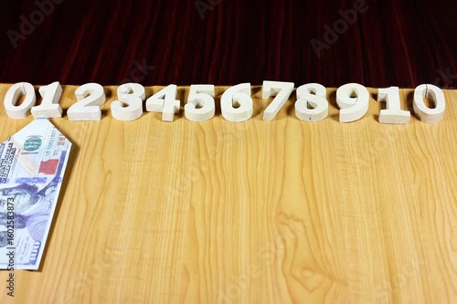 Stop motion animation of dollar bills and numbers.