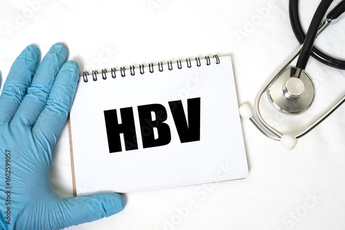 HBV in notebook isolated on bright white background. doctor's hand and stethoscope.