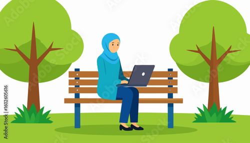 A woman in a blue hijab and tunic sits on a park bench, focused on her work on a laptop.