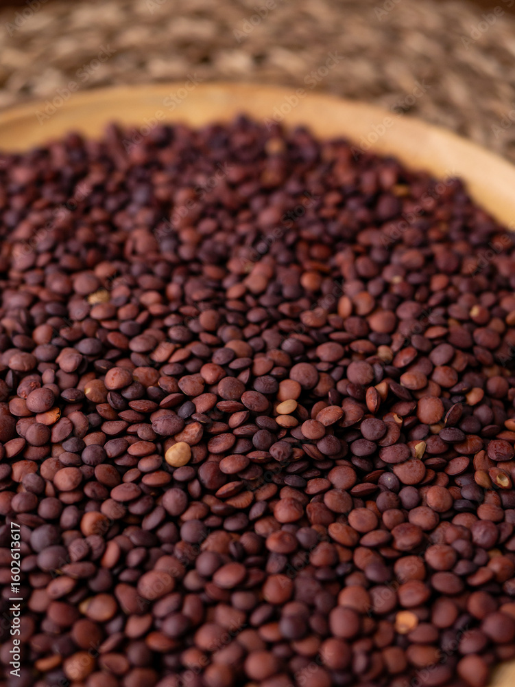 Fototapeta premium Organic uncooked seeds dark red brown lentils.
