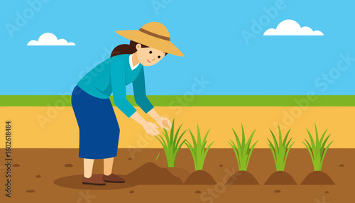Smiling female farmer in a straw hat and blue clothes planting green seedlings.