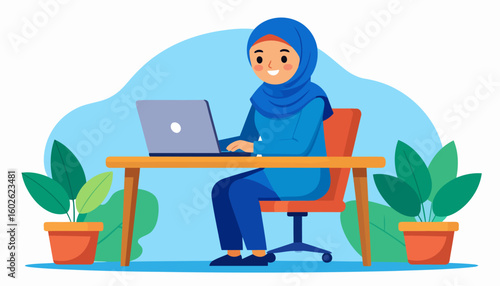 A cheerful Muslim woman in a blue hijab and tunic sits at a wooden desk, working on a laptop computer.