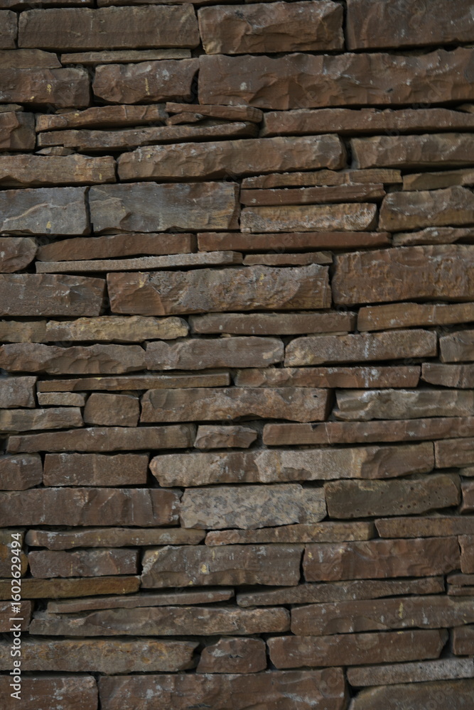 Fototapeta premium stacked natural brown stone wall, seamless pattern for background design