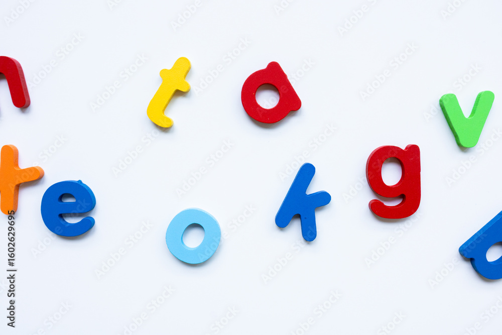 Fototapeta premium Colorful plastic alphabet letters on white background for educational activities