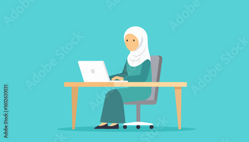 Muslim woman in a white hijab and teal dress working on a laptop at her office desk.