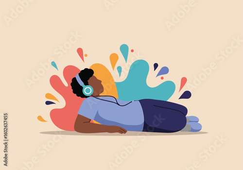 A person lies on the floor relaxing and listening to music on headphones, with colorful abstract splashes in the background.