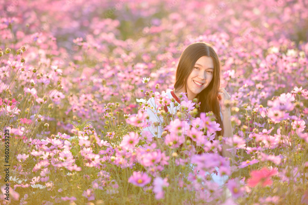Fototapeta premium Asian cute young woman joyful, smiling with flowers garden background.