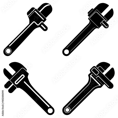 Four black adjustable wrenches arranged in a square pattern on a white isolated background view