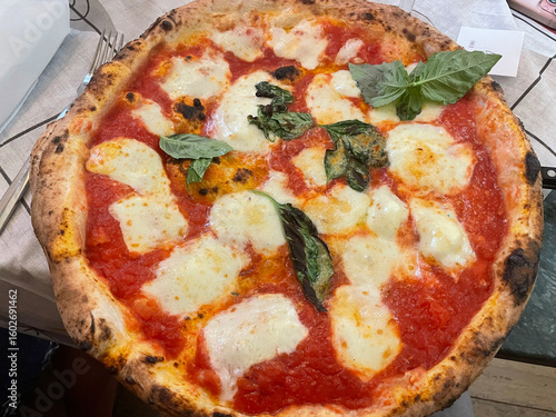 Close-up of a traditional Neapolitan pizza served on a ceramic plate