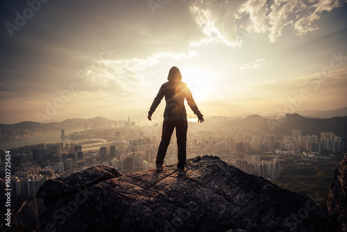 Photography Successful woman hiker on the mountain top cliff edge in Hong Kong