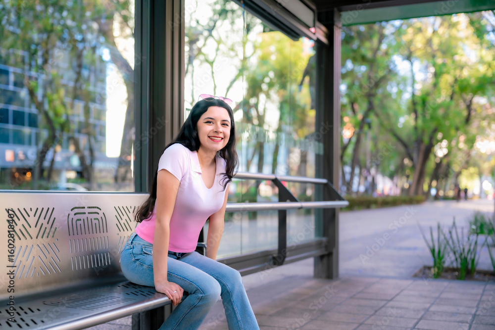 Fototapeta premium Smiling latina woman at metrobus stop in Reforma avenue