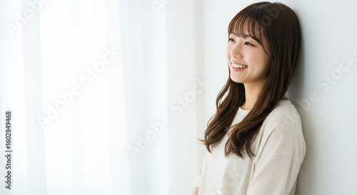 Natural Beauty of Young Asian Woman Smiling in Bright Minimalist Space Free Download Natural Beauty of Young Asian Woman Smiling in Bright Minimalist Space - GFXLoad