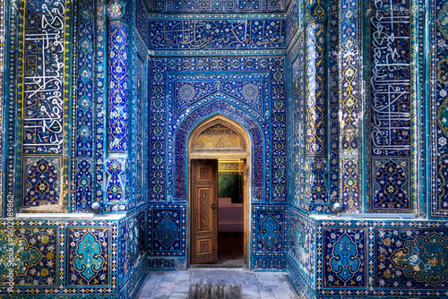 Samarkand, Uzbekistan - 05 June 2024: View of the Shah-i-Zinda necropolis entrance, adorned with intricate blue tilework and Arabic calligraphy, creating a mesmerizing spectacle of color and design.