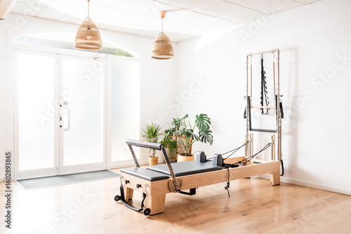 Pilates reformer and Cadillac equipment standing in a modern and bright studio