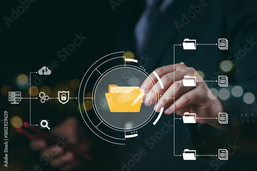 Document Management System (DMS) being setup by IT consultant working on laptop computer in office. Software for archiving, searching and managing corporate files and information