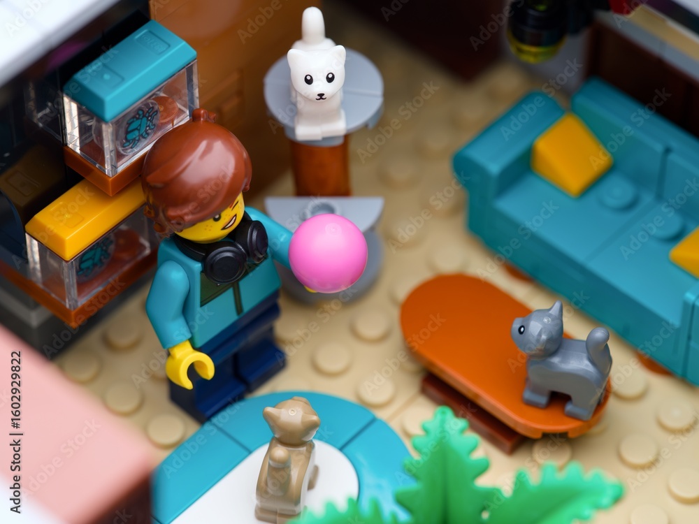 Obraz premium Tambov, Russian Federation - July 05, 2025 Lego girl minifigure playing with three Lego kittens in her apartment