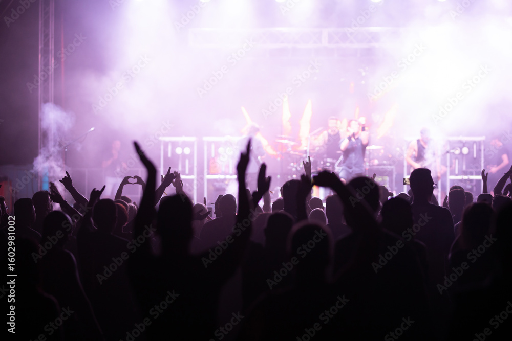 Obraz premium Crowd at concert and blurred stage lights.