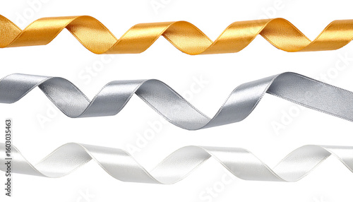 Fotografie Cut out image of white, silvery and golden satin ribbons, spiral-curled ribbons