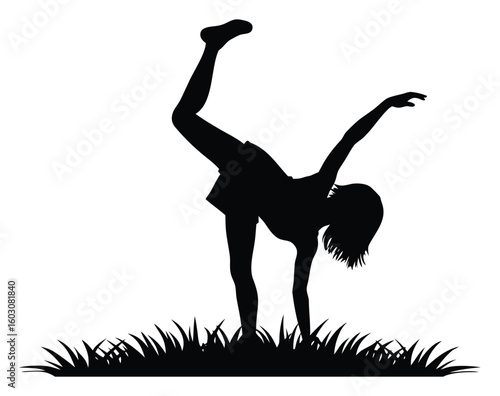 Silhouette of a Girl Doing a Cartwheel in the Grass Enjoying Outdoor Activity and Physical Fitness in Summer