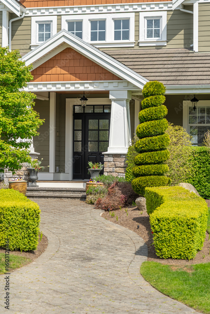 Obraz premium Entrance of painted luxury house in spring with stair steps and nice landscape in Vancouver, Canada, North America. Day time on May 2025.