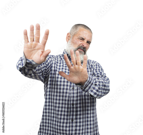 Bearded man gesturing stop with his hands, expressing disgust and rejection with a negative facial expression