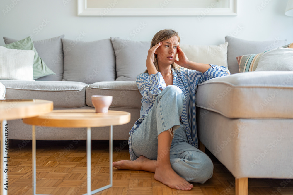 Woman Sitting on Floor Feeling Stressed in a Comfortable Home Interior Setting Woman Sitting on Floor Feeling Stressed in a Comfortable Home Interior Setting